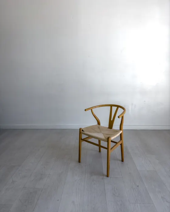 A wishbone chair in an empty room